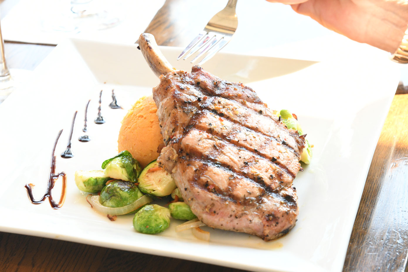 Beautifully plated pork chop, one of the items on the Yacht Club's menu.